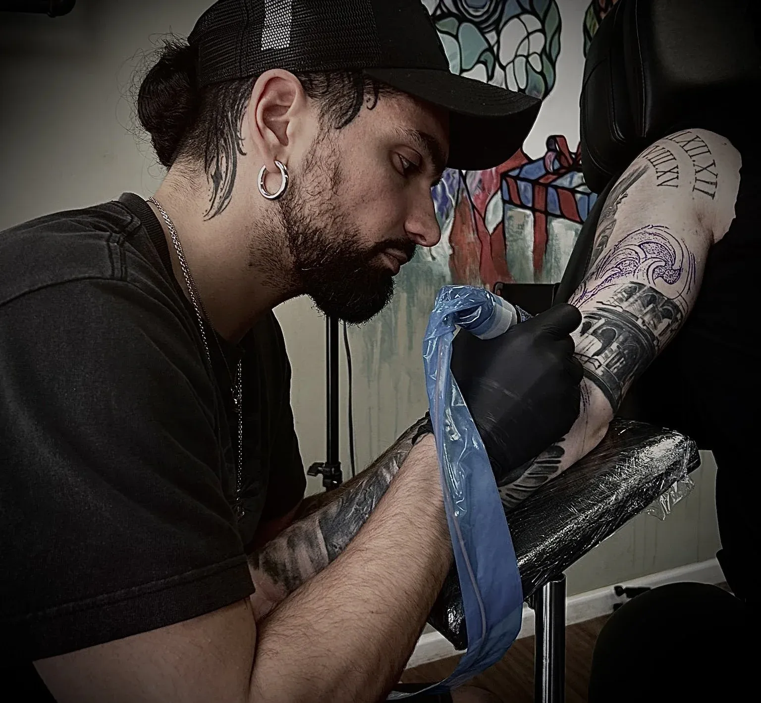 Antonio tattooing a realism sleeve at the studio in Maghull